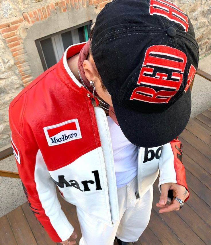 Person wearing a red and white jacket with Marlboro branding and a black cap with 'REDD' on it.