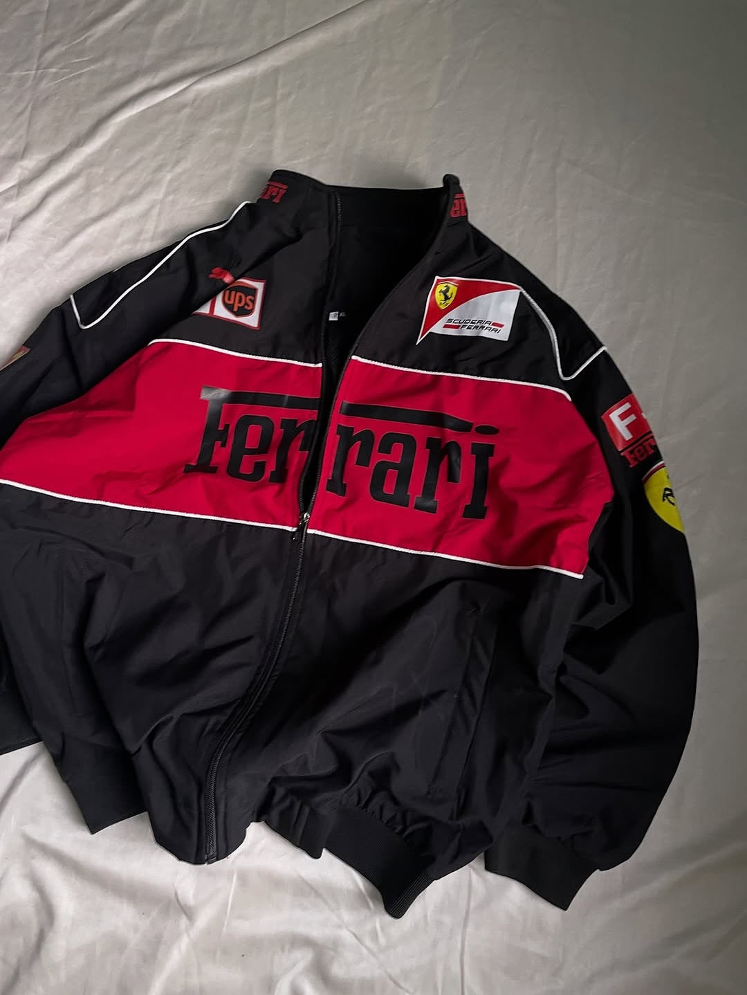 Black and red Ferrari tracksuit on a white background