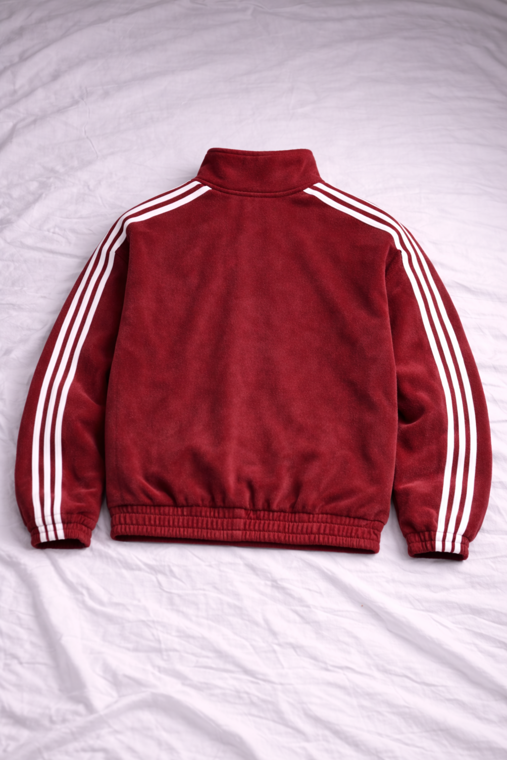 Red jacket with white stripes on sleeves and collar on a white background