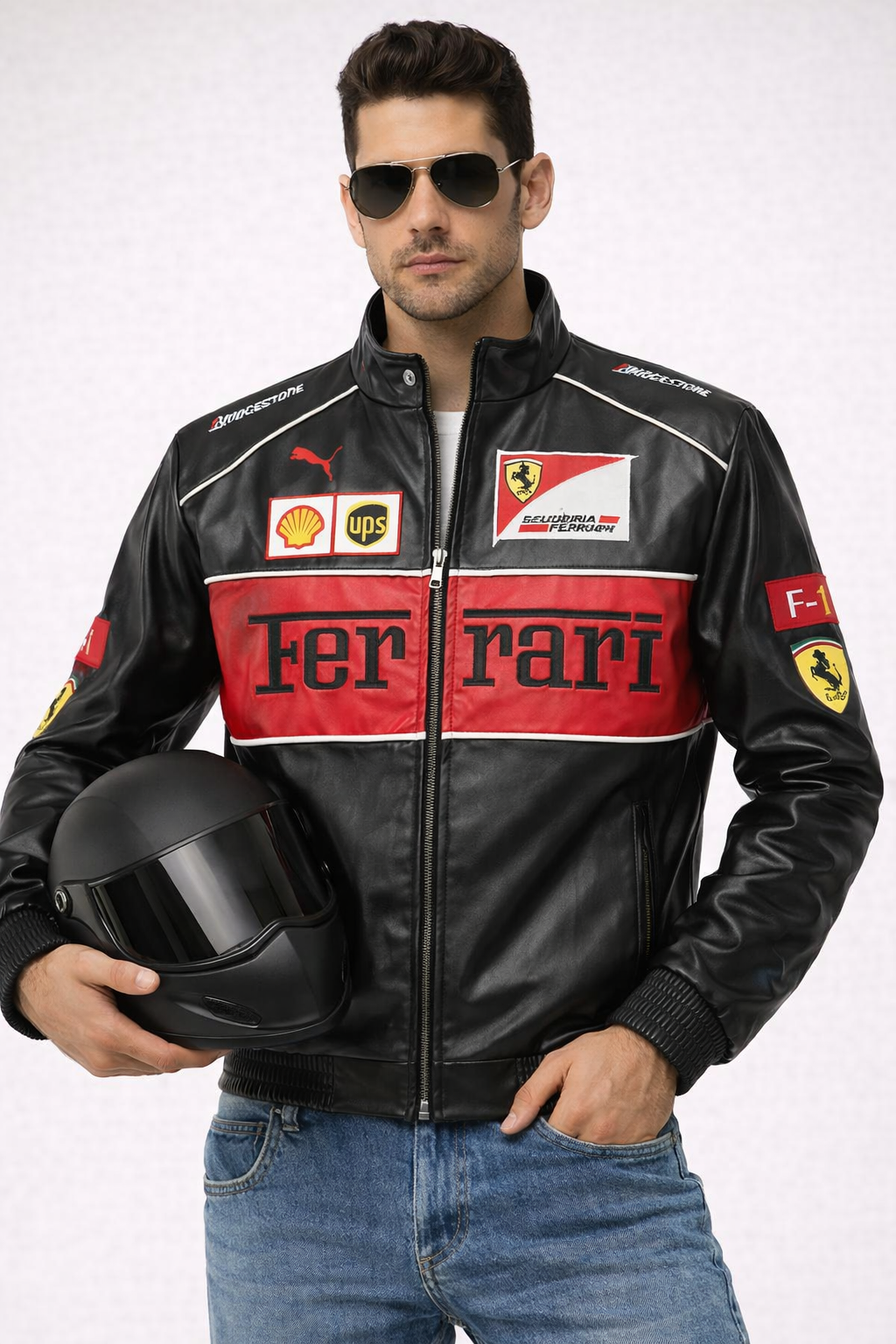 Man wearing a Ferrari leather jacket holding a helmet on a white background